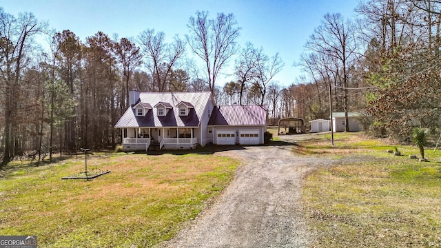 cape cod-style house featuring driveway, a porch, metal roof, an attached garage, and a front lawn