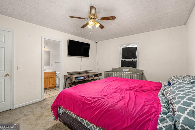 bedroom with light carpet, a textured ceiling, and connected bathroom
