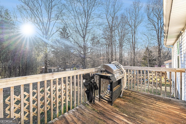 wooden terrace with a grill