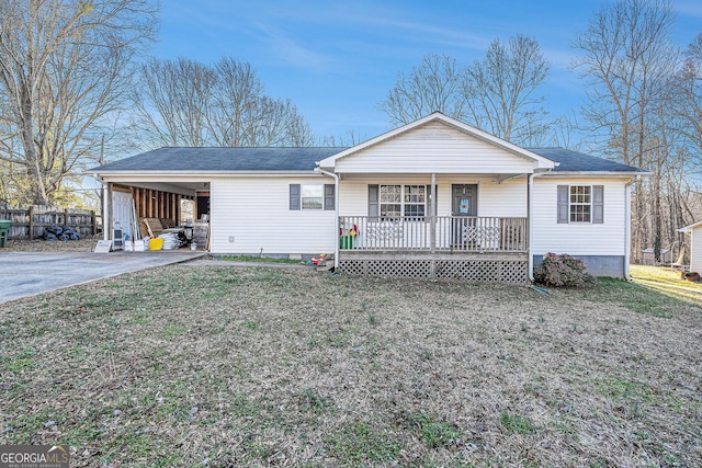 view of front of house with driveway, a front lawn, a porch, and a carport
