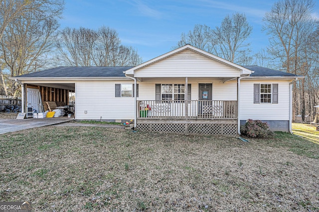 view of front facade featuring a carport, covered porch, driveway, and a front lawn