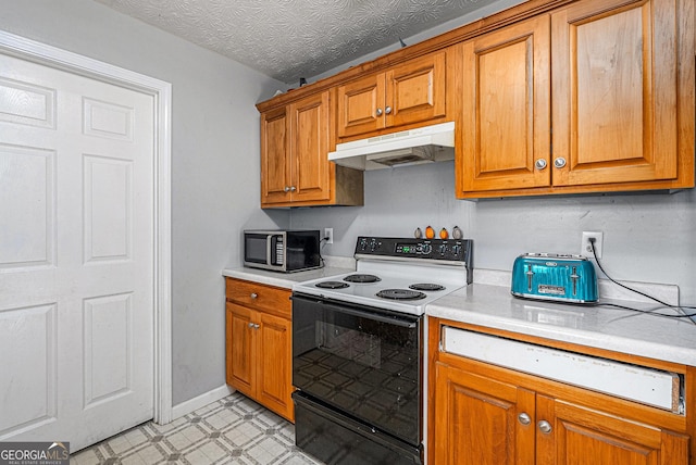 kitchen featuring under cabinet range hood, electric range, light countertops, brown cabinetry, and stainless steel microwave