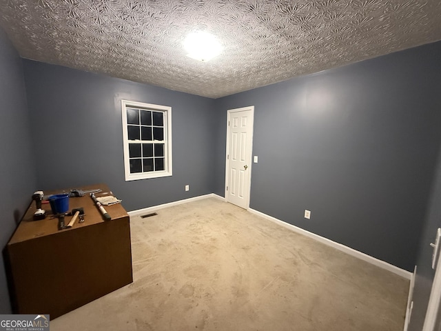 unfurnished bedroom featuring carpet floors, baseboards, visible vents, and a textured ceiling