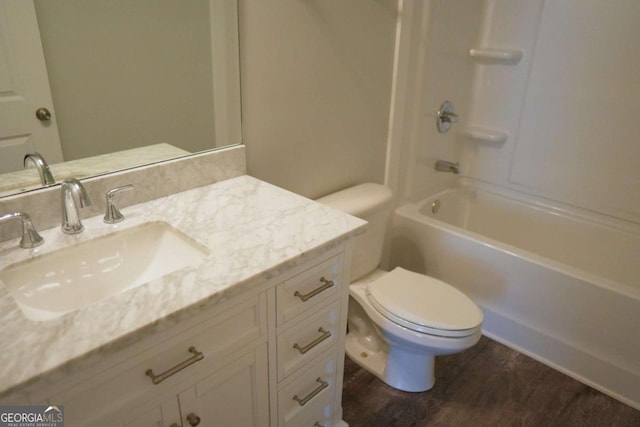 full bathroom featuring vanity, shower / bathing tub combination, wood finished floors, and toilet