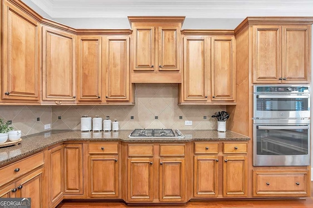 7524 Portbury Park Ln, Suwanee, GA 30024 - kitchen with brown cabinets, stainless steel appliances, dark stone counters, and decorative backsplash