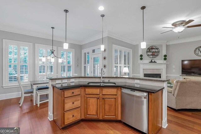 7524 Portbury Park Ln, Suwanee, GA 30024 - kitchen with decorative light fixtures, brown cabinetry, open floor plan, a sink, and dishwasher