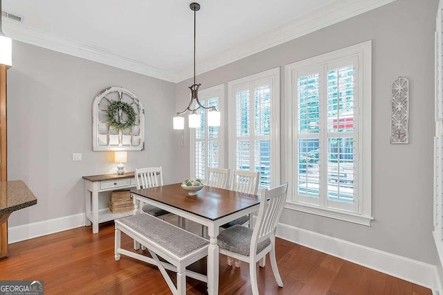 7524 Portbury Park Ln, Suwanee, GA 30024 - dining room featuring crown molding, a notable chandelier, visible vents, dark wood-type flooring, and baseboards