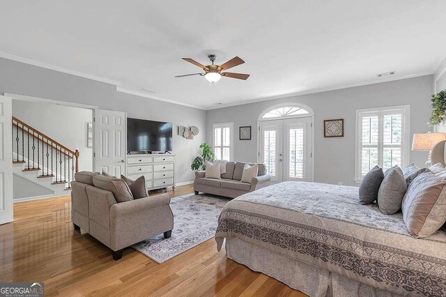 7524 Portbury Park Ln, Suwanee, GA 30024 - bedroom with french doors, multiple windows, visible vents, and wood finished floors