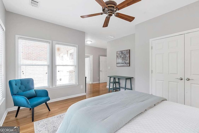 7524 Portbury Park Ln, Suwanee, GA 30024 - bedroom with baseboards, visible vents, a ceiling fan, wood finished floors, and a closet