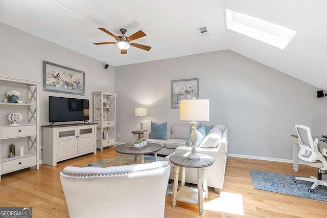 7524 Portbury Park Ln, Suwanee, GA 30024 - living room with visible vents, lofted ceiling with skylight, ceiling fan, wood finished floors, and baseboards