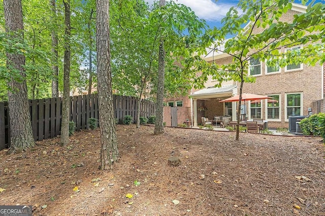 7524 Portbury Park Ln, Suwanee, GA 30024 - view of yard featuring a fenced backyard, central AC, and a patio