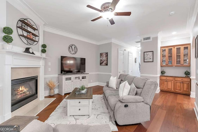 7524 Portbury Park Ln, Suwanee, GA 30024 - living area featuring light wood-style flooring, visible vents, crown molding, and a glass covered fireplace