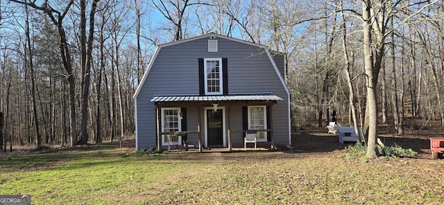 dutch colonial with a front yard and a gambrel roof