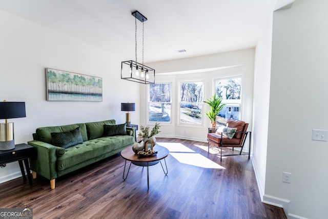 living area featuring dark wood finished floors and baseboards