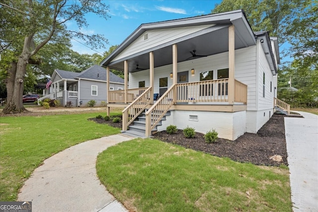 view of front of house featuring a ceiling fan, a porch, crawl space, stairs, and a front lawn