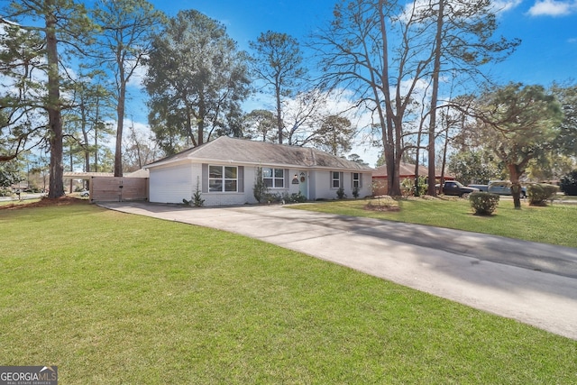 single story home featuring driveway, a front yard, and brick siding