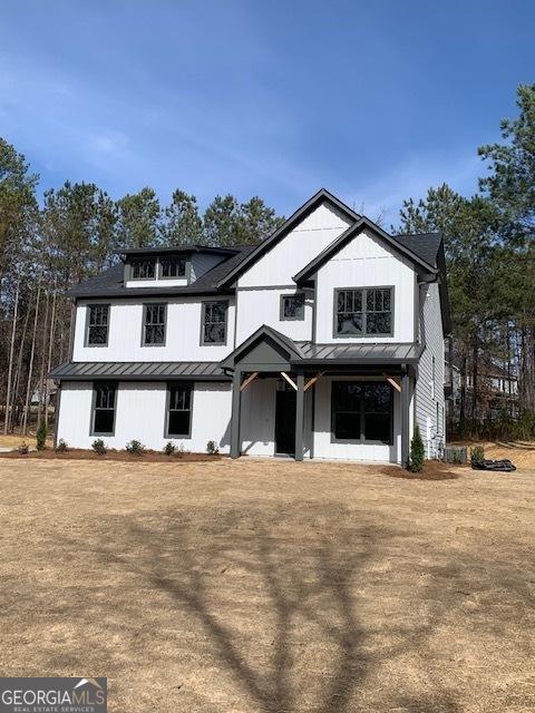 modern farmhouse featuring a standing seam roof and metal roof