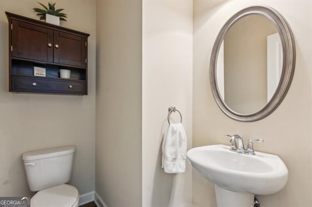 7420 Glisten Ave, Sandy Springs, GA 30328 - bathroom featuring a sink, toilet, and baseboards