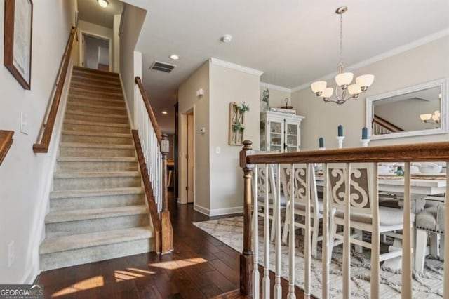 7420 Glisten Ave, Sandy Springs, GA 30328 - staircase featuring a chandelier, wood finished floors, visible vents, baseboards, and crown molding