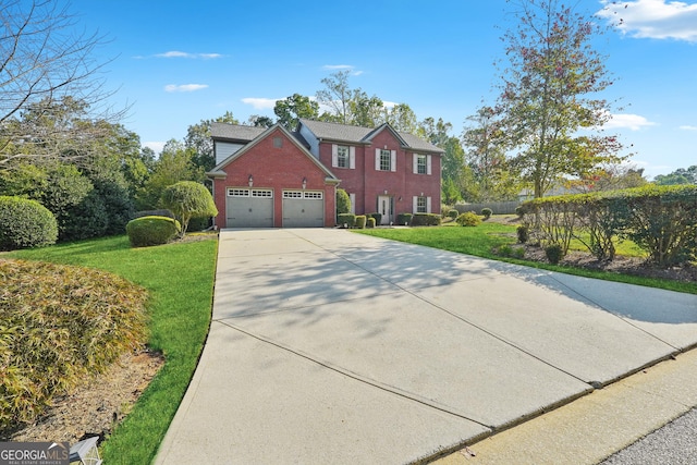 colonial home featuring a garage, a front lawn, concrete driveway, and brick siding