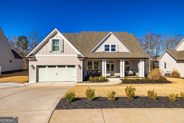 view of front of property with driveway, a garage, roof with shingles, covered porch, and board and batten siding