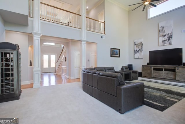 8910 Champion Ct, Ball Ground, GA 30107 - living area with ornate columns, carpet floors, a high ceiling, a ceiling fan, and stairway