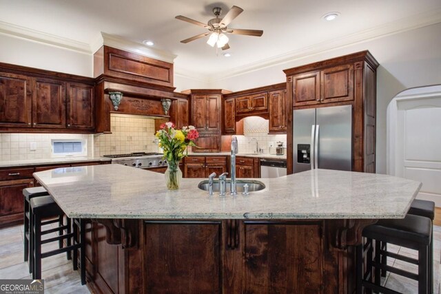 8910 Champion Ct, Ball Ground, GA 30107 - kitchen featuring appliances with stainless steel finishes, a sink, ceiling fan, a kitchen breakfast bar, and recessed lighting