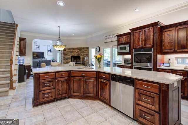 8910 Champion Ct, Ball Ground, GA 30107 - kitchen featuring appliances with stainless steel finishes, a sink, open floor plan, light tile patterned floors, and ornamental molding