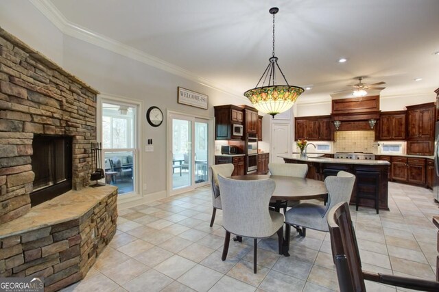 8910 Champion Ct, Ball Ground, GA 30107 - dining area featuring light tile patterned floors, ornamental molding, ceiling fan, a fireplace, and recessed lighting