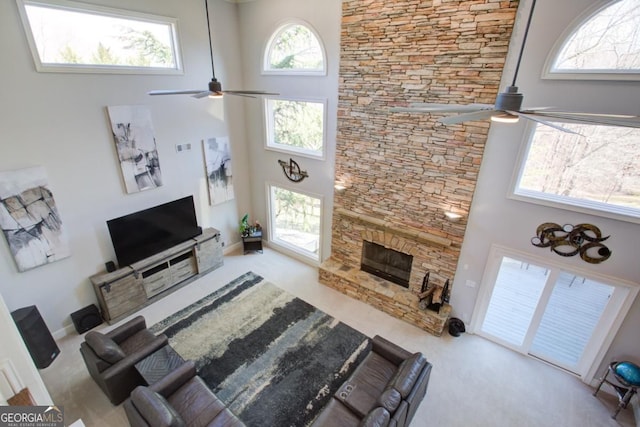 8910 Champion Ct, Ball Ground, GA 30107 - carpeted living area with a ceiling fan, a high ceiling, and a fireplace