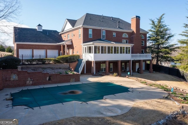 8910 Champion Ct, Ball Ground, GA 30107 - back of property with a sunroom, stairway, a patio area, and a chimney