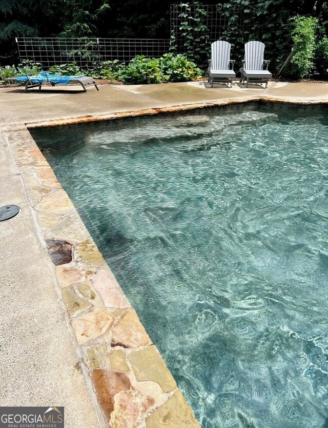 8910 Champion Ct, Ball Ground, GA 30107 - swimming pool with a patio area