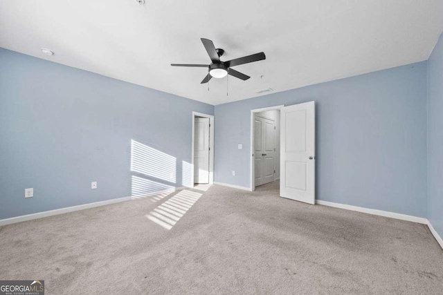 unfurnished bedroom with light colored carpet, ceiling fan, and baseboards