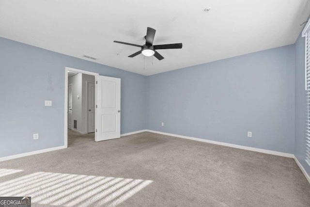 unfurnished bedroom featuring light colored carpet, visible vents, and baseboards