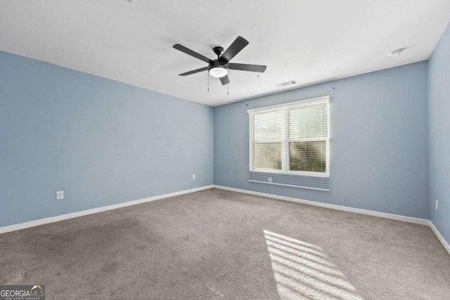 unfurnished room featuring ceiling fan, carpet flooring, visible vents, and baseboards