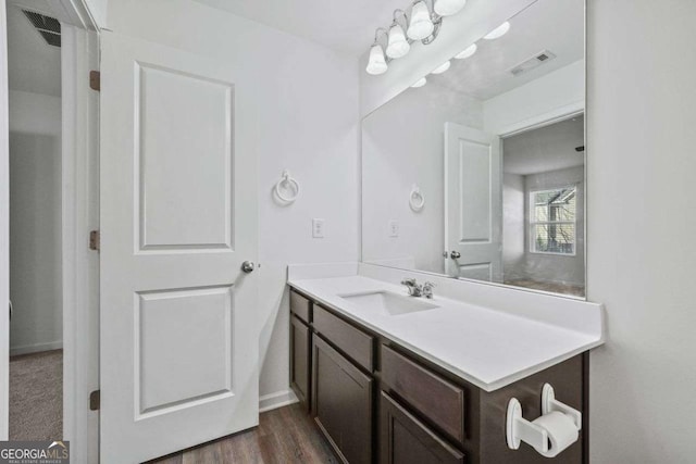 bathroom featuring visible vents, wood finished floors, and vanity