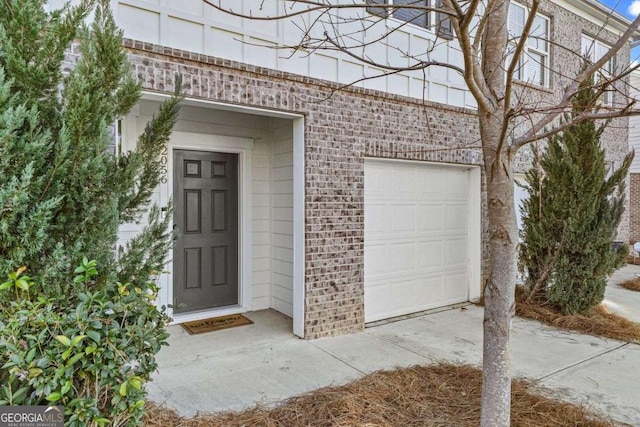 entrance to property featuring brick siding