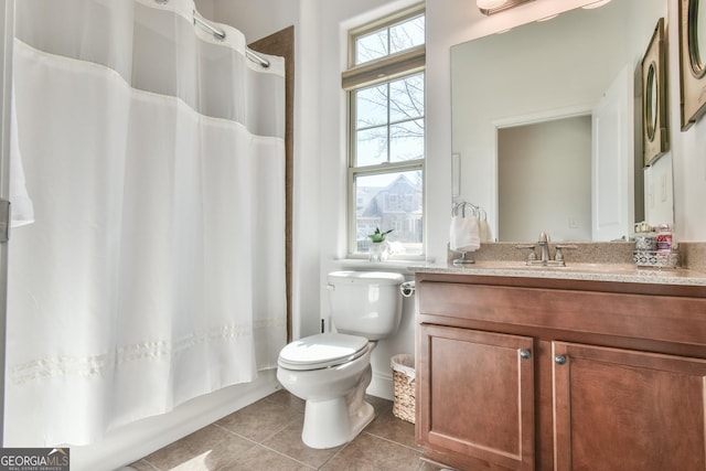 full bathroom featuring toilet, vanity, tile patterned flooring, and shower / bath combo with shower curtain