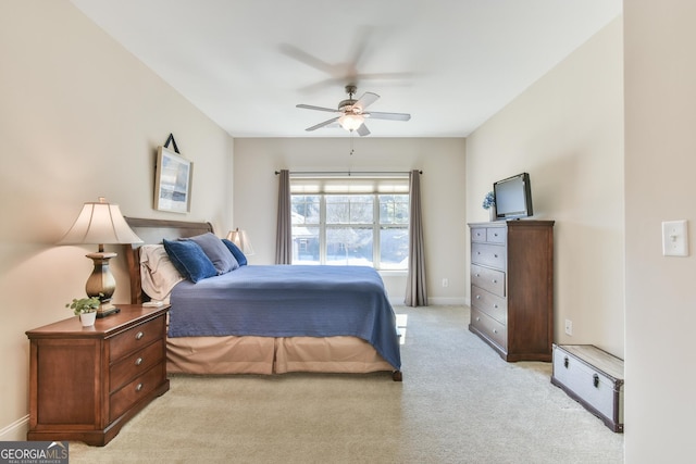 bedroom with light carpet, baseboards, and a ceiling fan