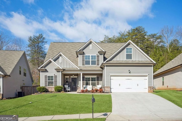 craftsman inspired home featuring driveway, board and batten siding, and a front yard