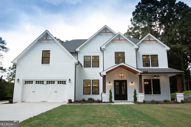 view of front of property with driveway, a garage, board and batten siding, and a front yard