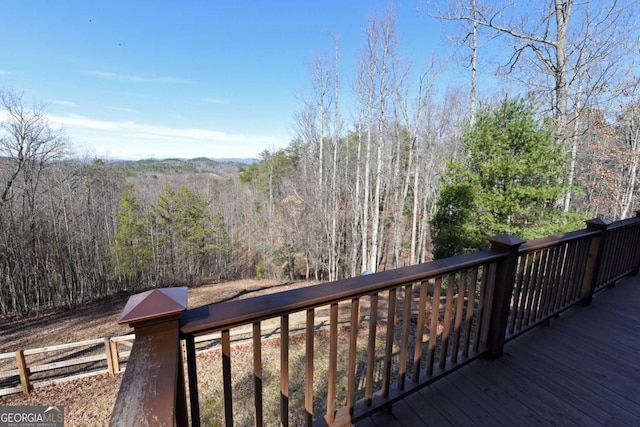 wooden deck featuring a wooded view