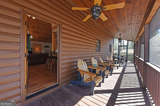 wooden terrace featuring a ceiling fan