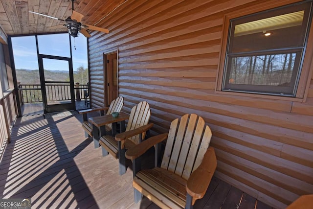 wooden deck with a ceiling fan