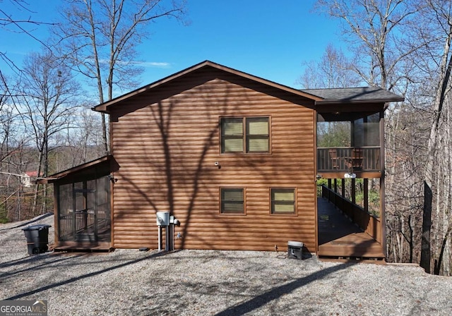 rear view of property with a sunroom