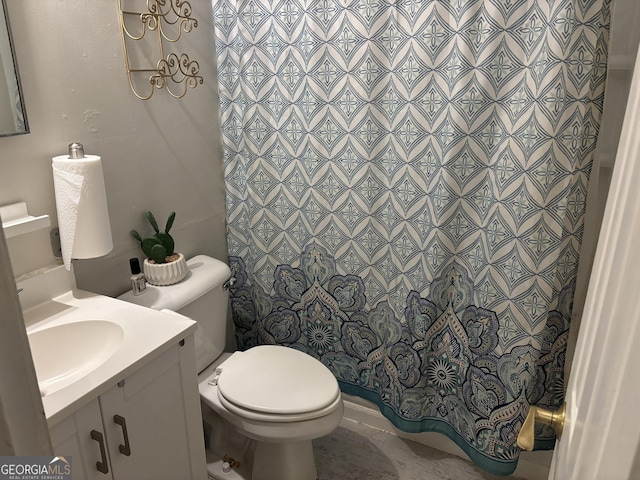 bathroom featuring curtained shower, toilet, and vanity