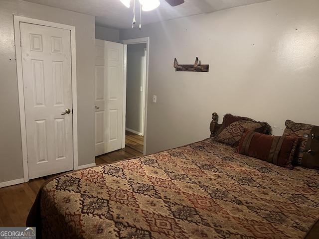 bedroom with wood finished floors, baseboards, and ceiling fan