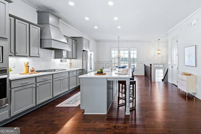 kitchen with custom range hood, appliances with stainless steel finishes, light countertops, and gray cabinetry