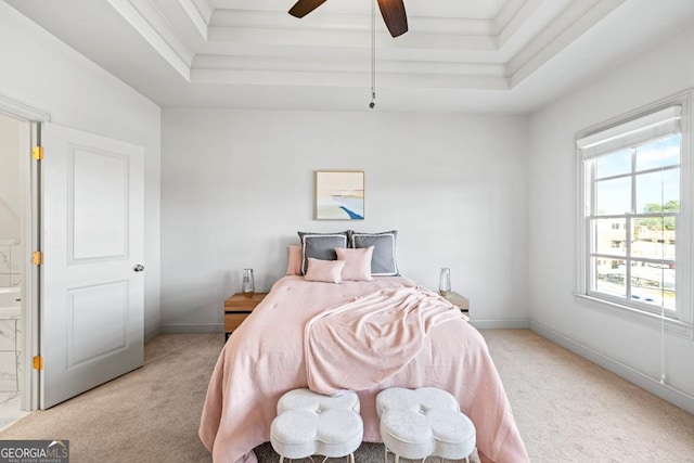 bedroom with ceiling fan, baseboards, a raised ceiling, and light colored carpet