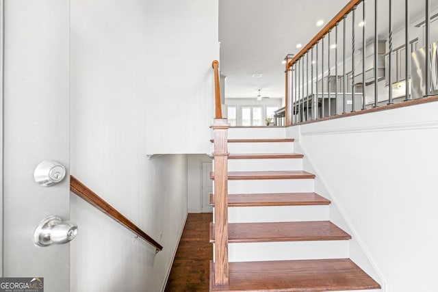 stairway with wood finished floors